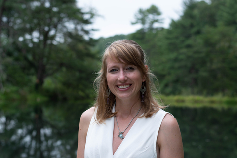 Dr. Stephanie Siemek with greenery in the background. 