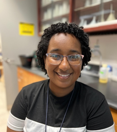 Image of Zoma Atnafou smiling in a laboratory