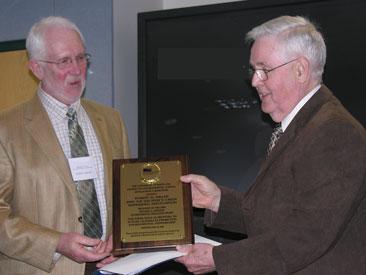 Photo of Robert Miller accepting 2009 Richard A. Johnson Environmental Education Award from Laboratory Director, Robert H. Gardner.
