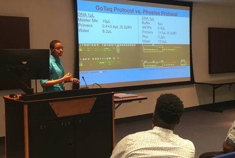 A student gives a presentation at the IMET summer internship program.