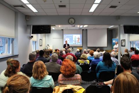 The public gathers for a science seminar.