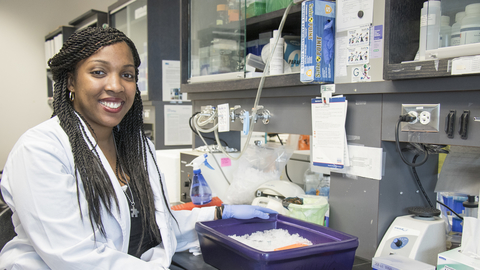 Shadaesha Green in a lab coat in the lab