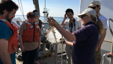 Professor Judy O'Neil shows the students a net that will be used to catch plankton from the Choptank River.