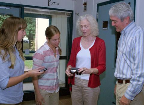 Kathy and Mike Quattrone of Chesapeake Seasons, Inc. based in Bozman, Maryland explain a special underwater camera to Horn Point Laboratory graduate students Melanie Jackson and Cassie Gurbitz.