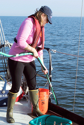 Lora Harris works to collect water samples aboard the R/V Kerhin. Studying how storms change the Bay's water chemistry and carbon consumption can better our understanding of its water quality problems.