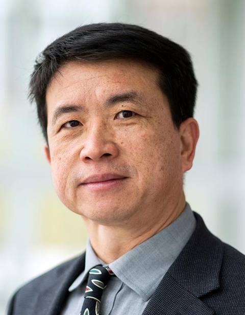 Headshot of Dr. Ning Zeng in black suit, grey shirt, and patterned tie. 