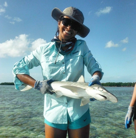 Samara Nehemiah holding a small reef shark