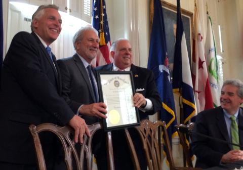 Gov. Larry Hogan presents UMCES President Don Boesch with a Maryland governor's citation while Virginia Gov. Terry McAuliffe (far left) looks on. 