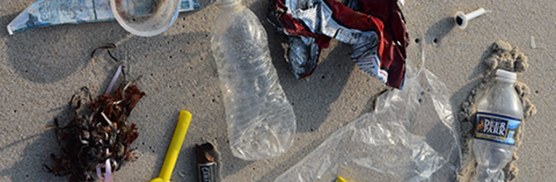 plastic waste on the beach sand