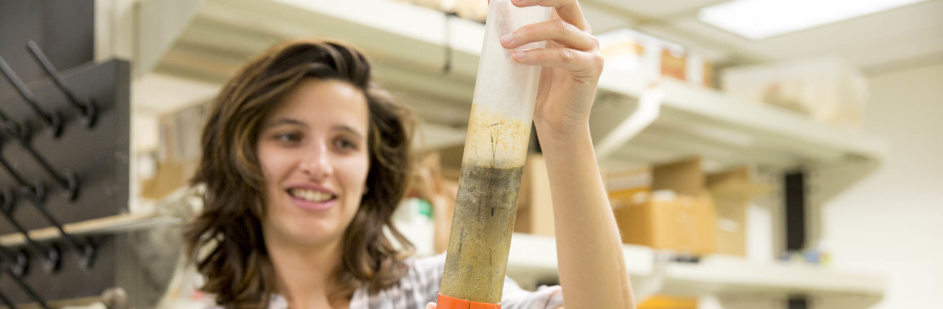 Emily Russ, a graduate student at Horn Point, holds up a sample of sediment. Photo by Cheryl Nemazie