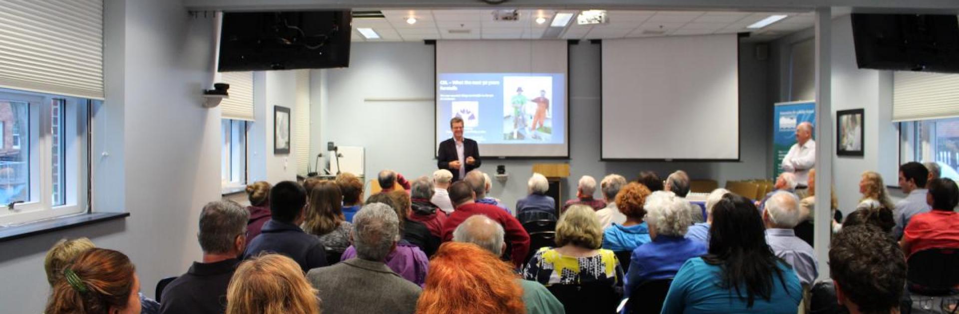 The public gathers for a science seminar.