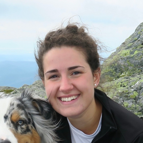 Annie smiling with her dog