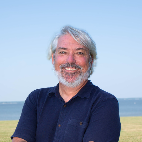 Photo of James Pierson with a field and the Choptank River in the distance.