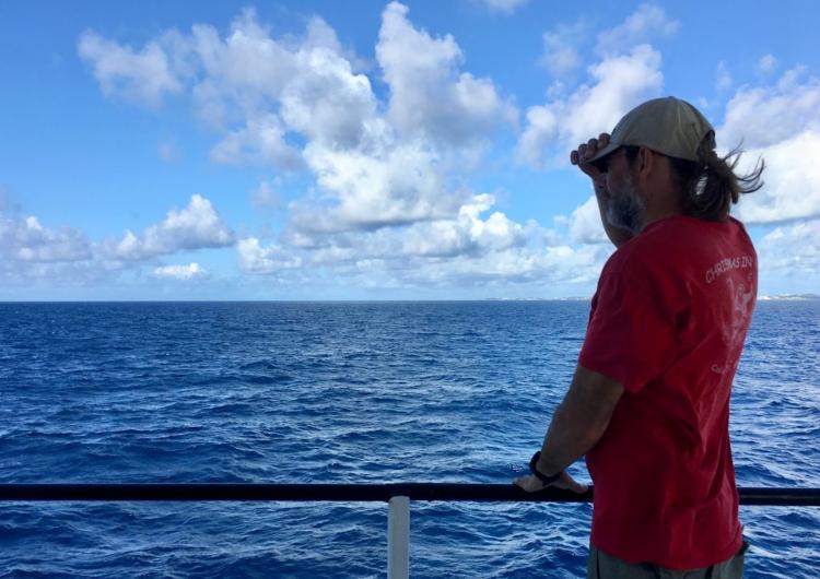 Scientist Michael Gonsior on deck of research vessel looking out onto the deep Atlantic Ocean