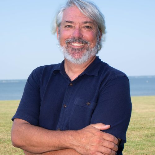 Photo of James Pierson with a field and the Choptank River in the distance.