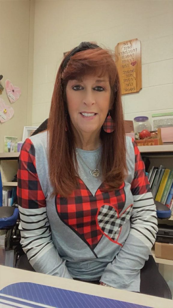 Thelma Louise Grogg seated at her desk in the classroom.