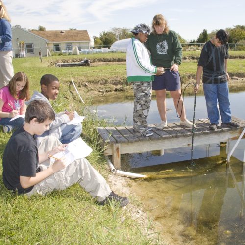 Students on the water at an education facility