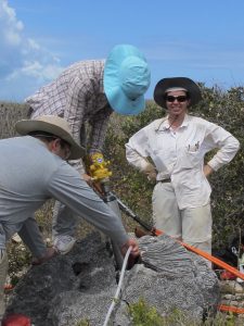Dr. Kilbourne supervises CBL Master's student Yuan-yuan Xu and University of Puerto Rico MS student Edgardo Quiñones drill a core into a brain coral deposited inland by a tsunami.
