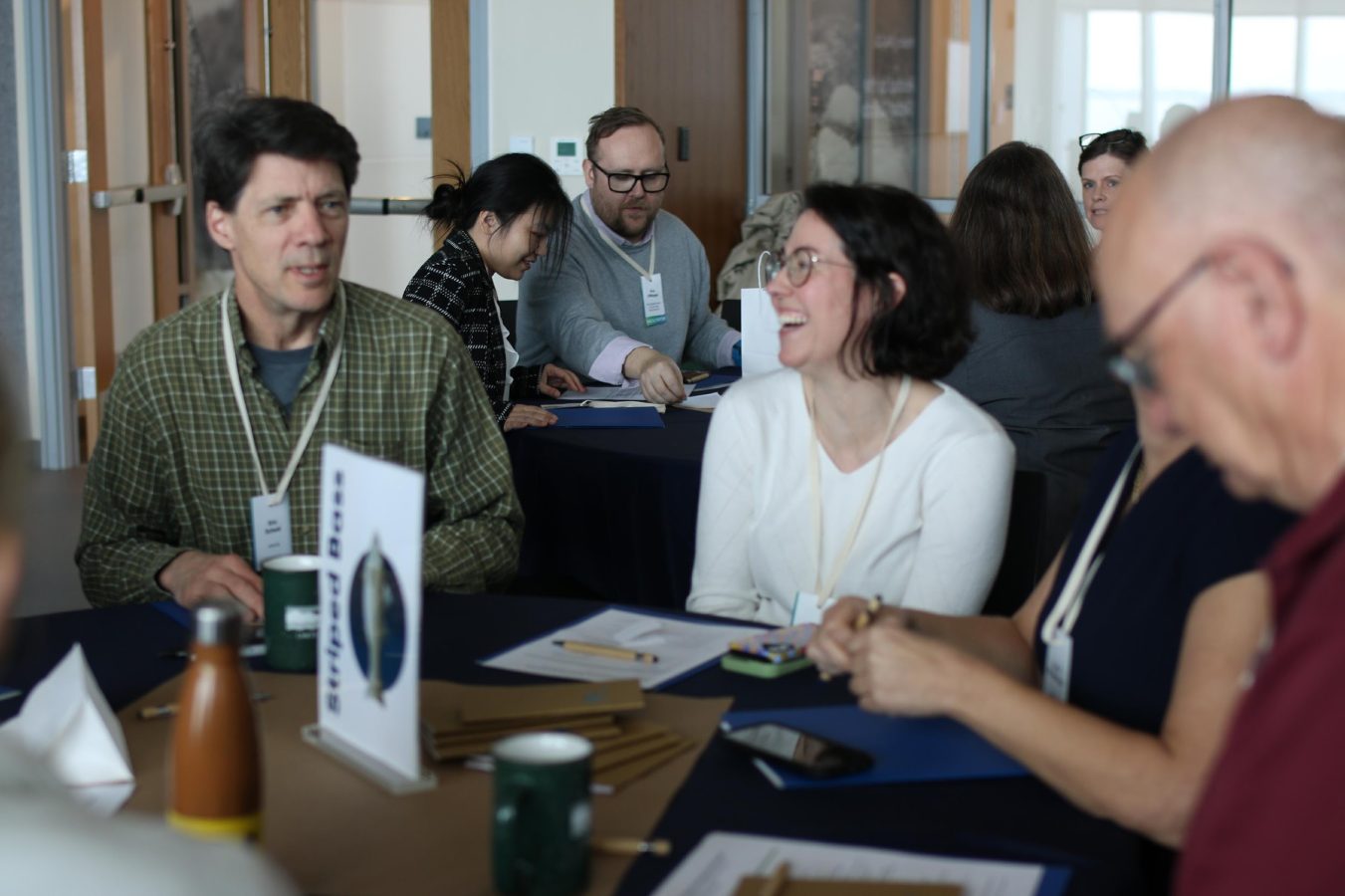 A group of attendees discuss and collaborate