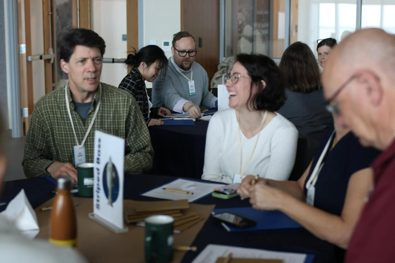A group of attendees discuss and collaborate
