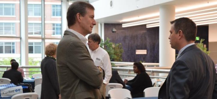Businessmen involved in a networking conversation