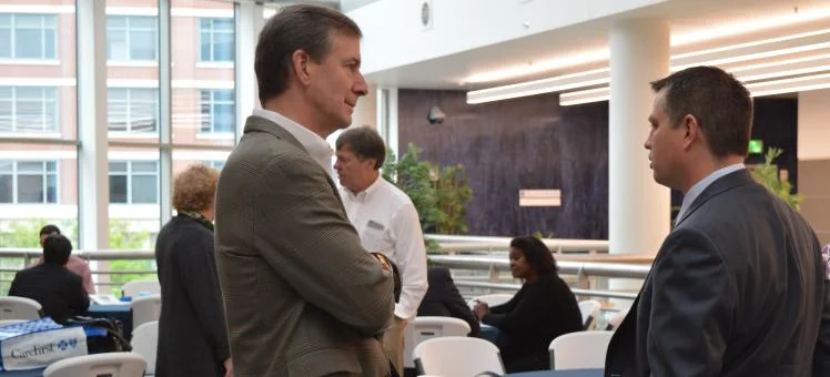 Businessmen involved in a networking conversation