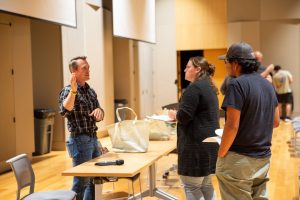 Dr. Ryan Woodland speaks with attendees following 2025 Watershed Moments event.