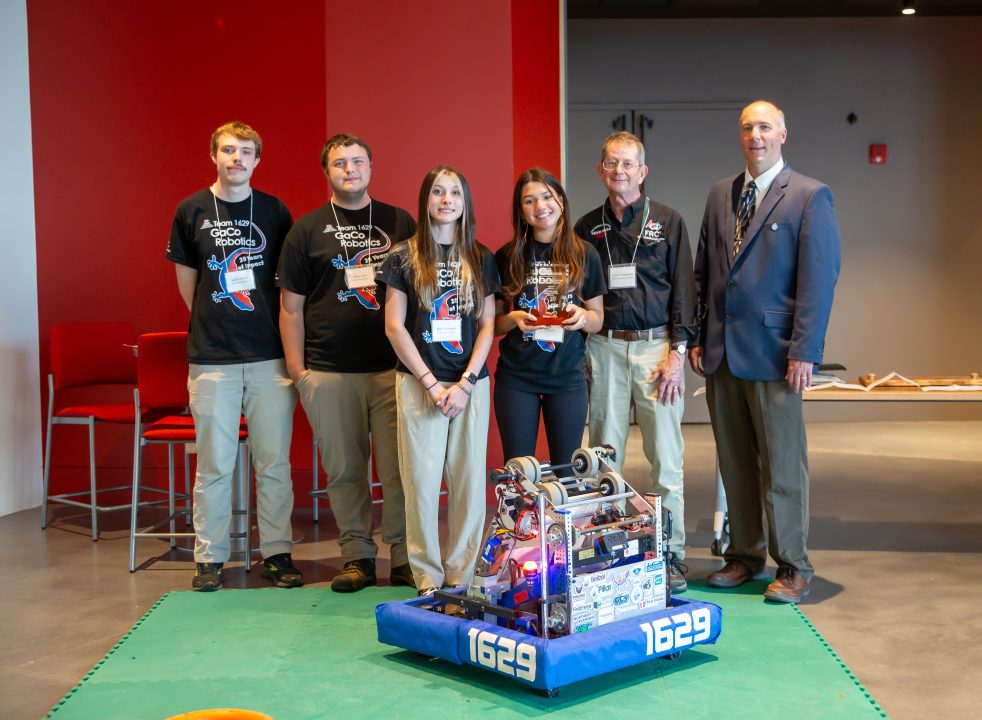 Garrett Coalition mentors and the team's 2024 robot with their award.