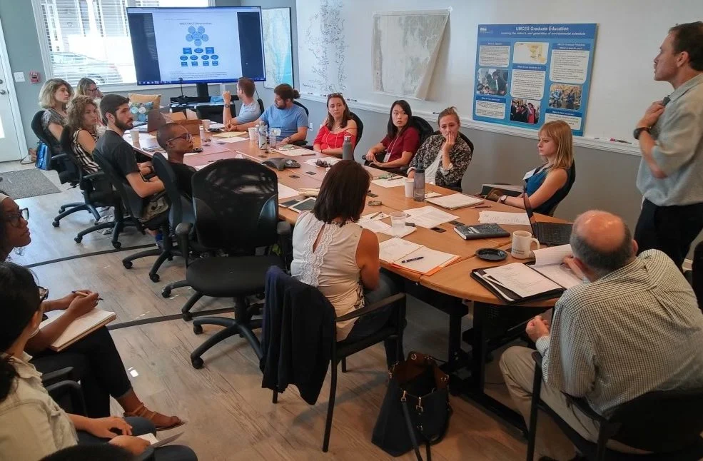Adults studying around a table