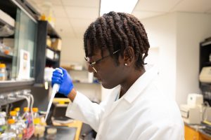 Summer intern using a pipette