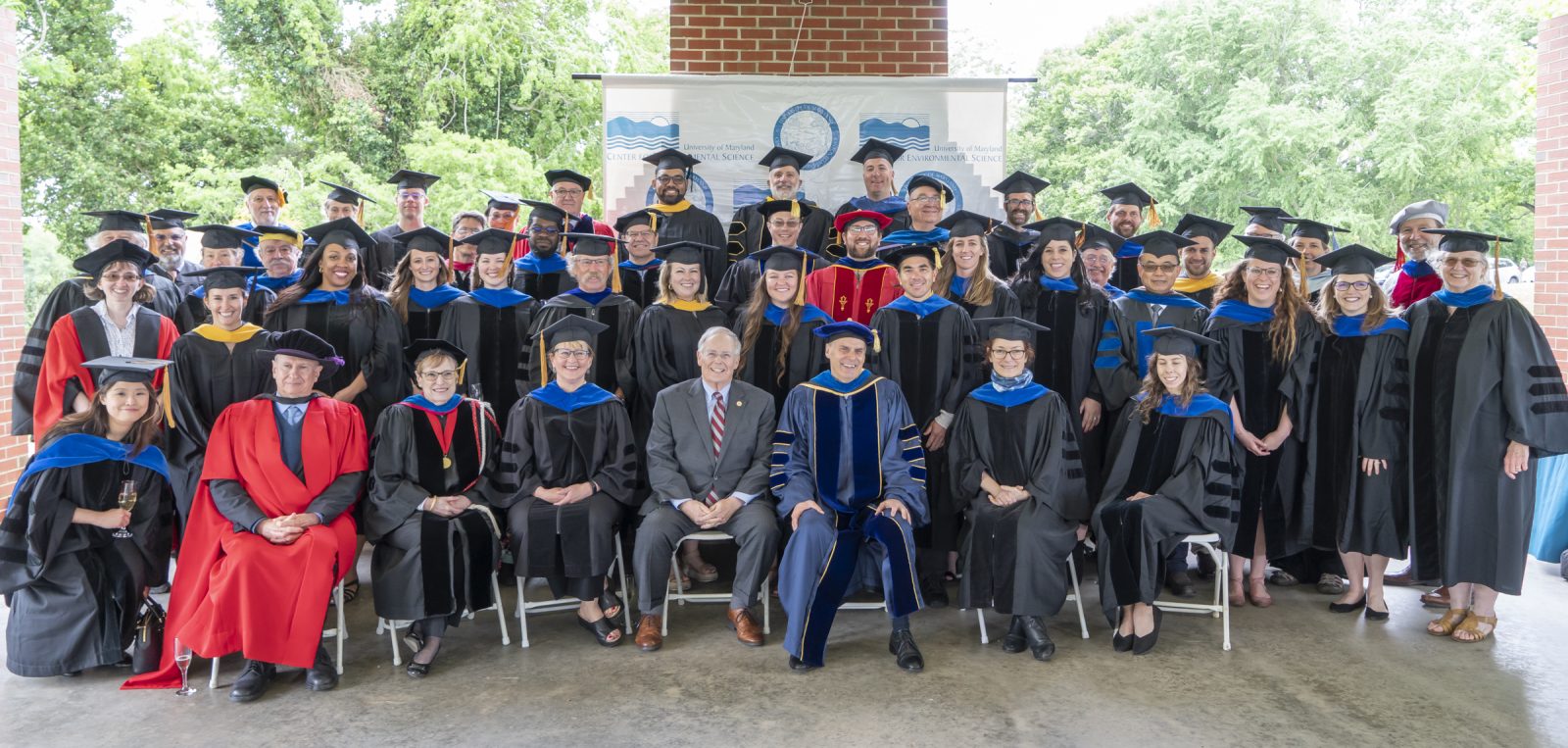Group shot of graduates and faculty at commencement 2022