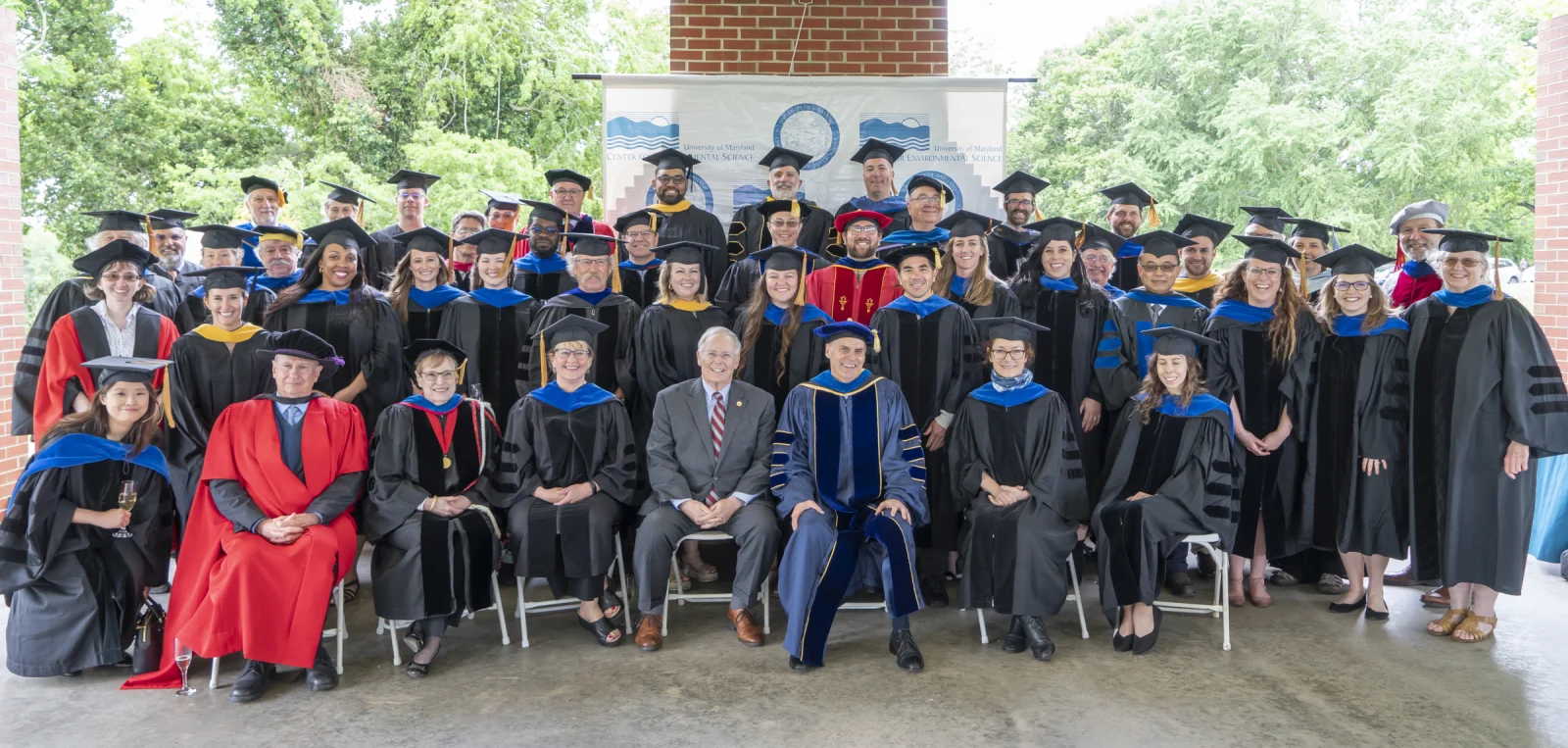 Group shot of graduates and faculty at commencement 2022