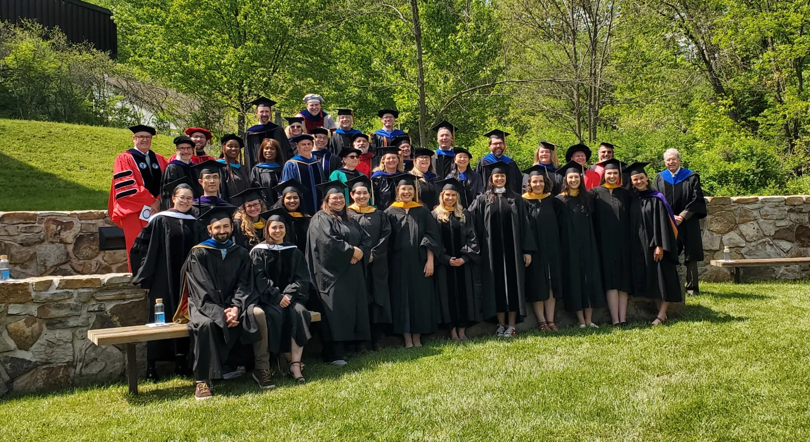Group shot of graduates and faculty at commencement 2023