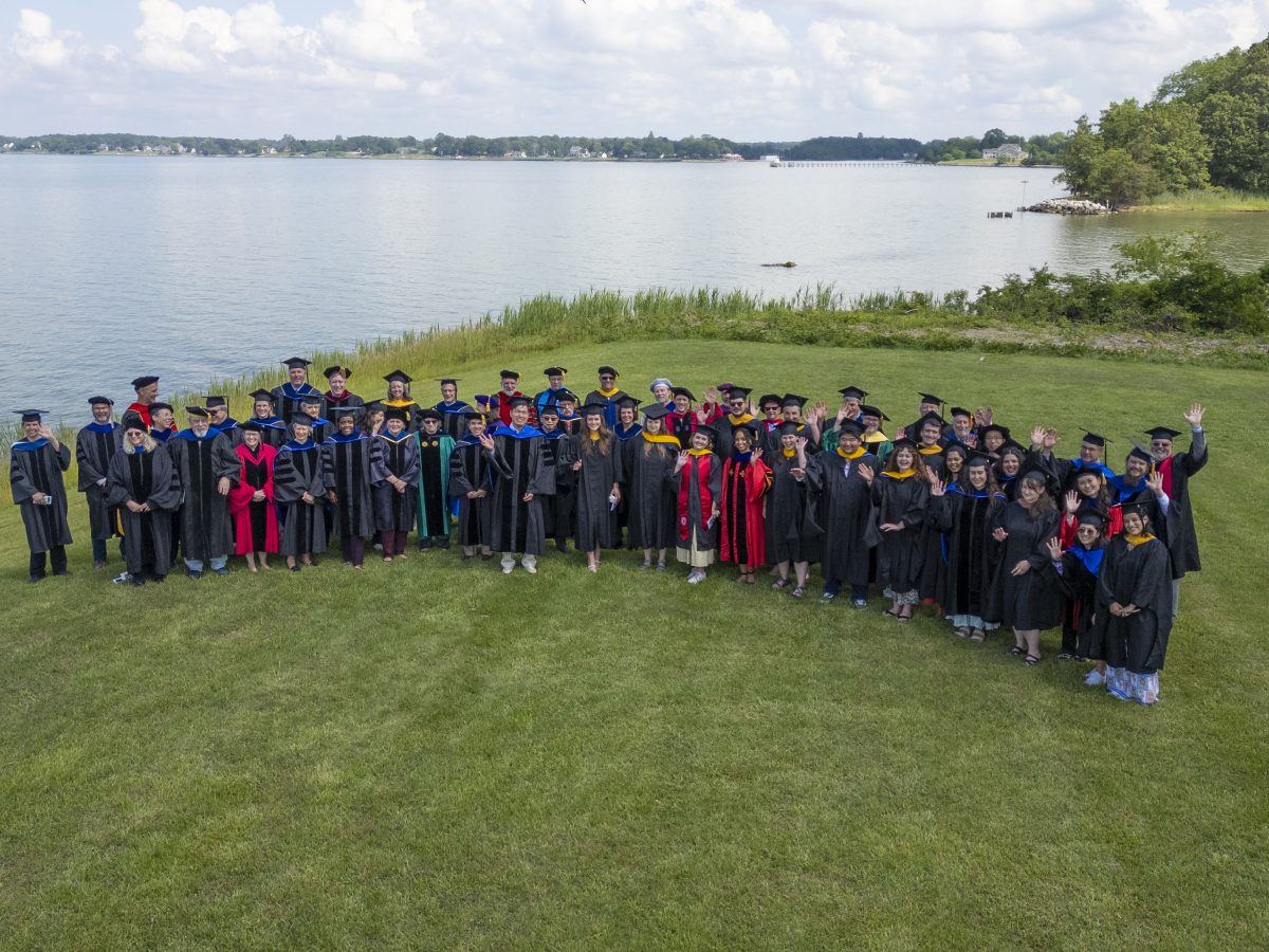 Group shot of graduates and faculty at commencement 2025
