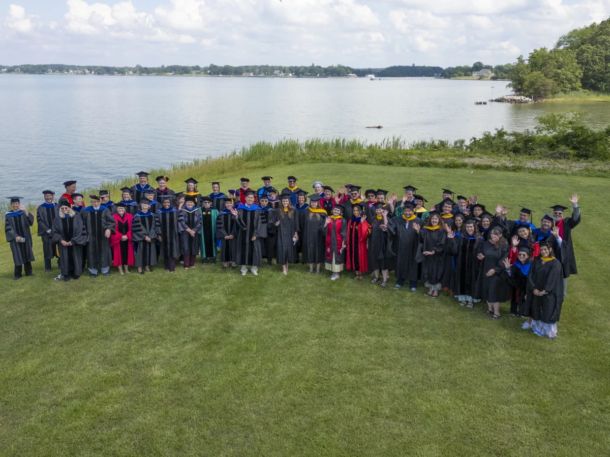 Group shot of graduates and faculty at commencement 2025