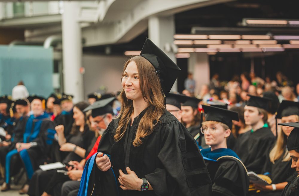 Graduate Miranda Judd at commencement before being hooded.