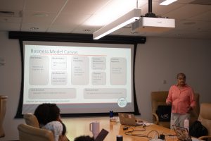 Dr. Nina Lamba presenting a business model canvas to the IMET Summer Interns 