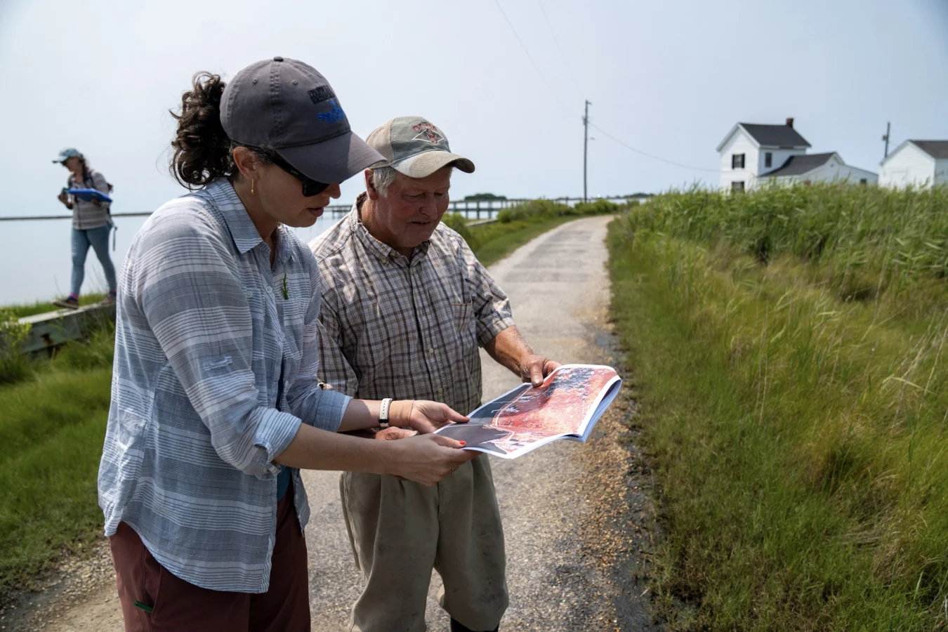A Maryland Sea Grant extension specialist consults with a landowner, who shows her a map