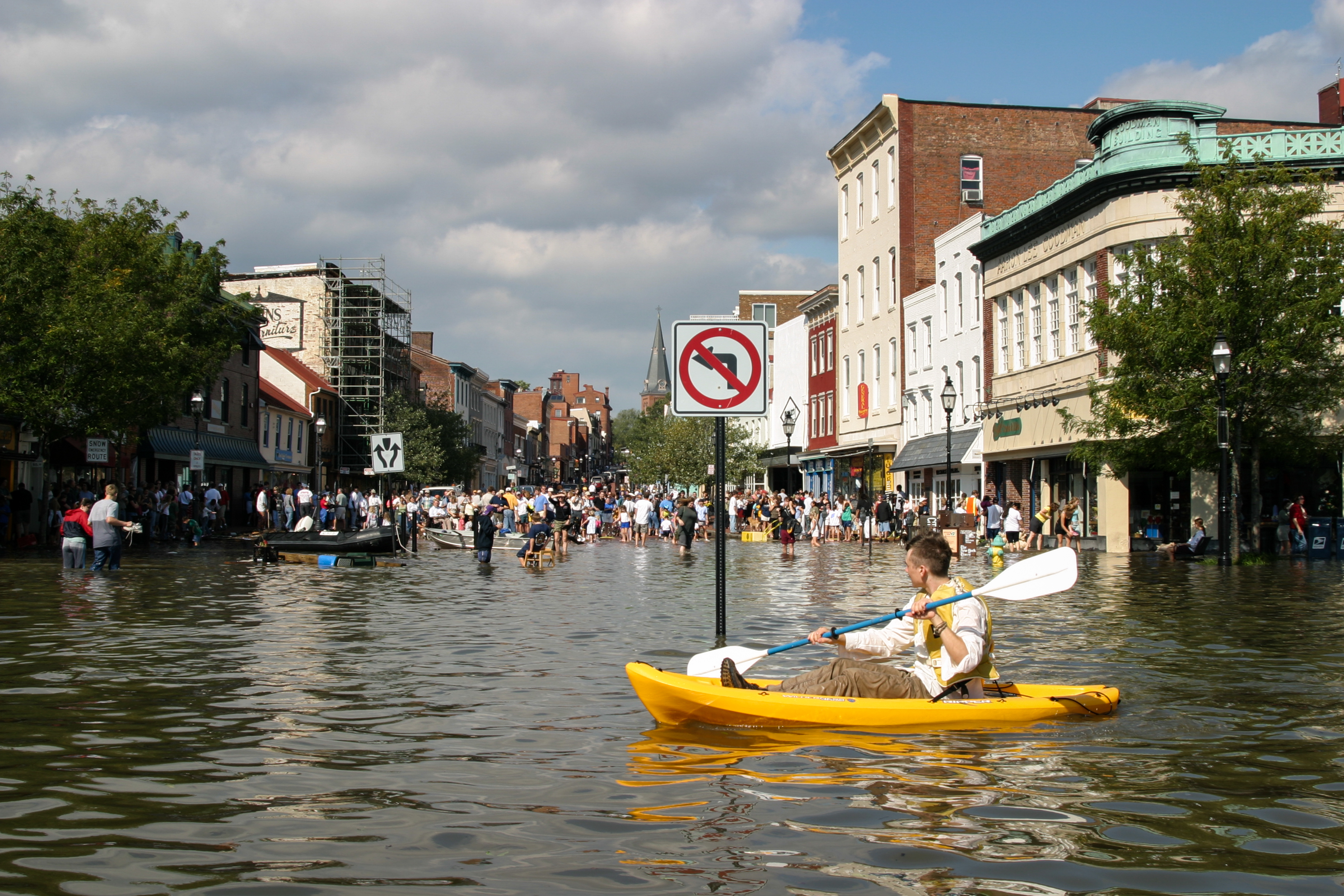 Annapolis flooded, a person kayaks in the street.