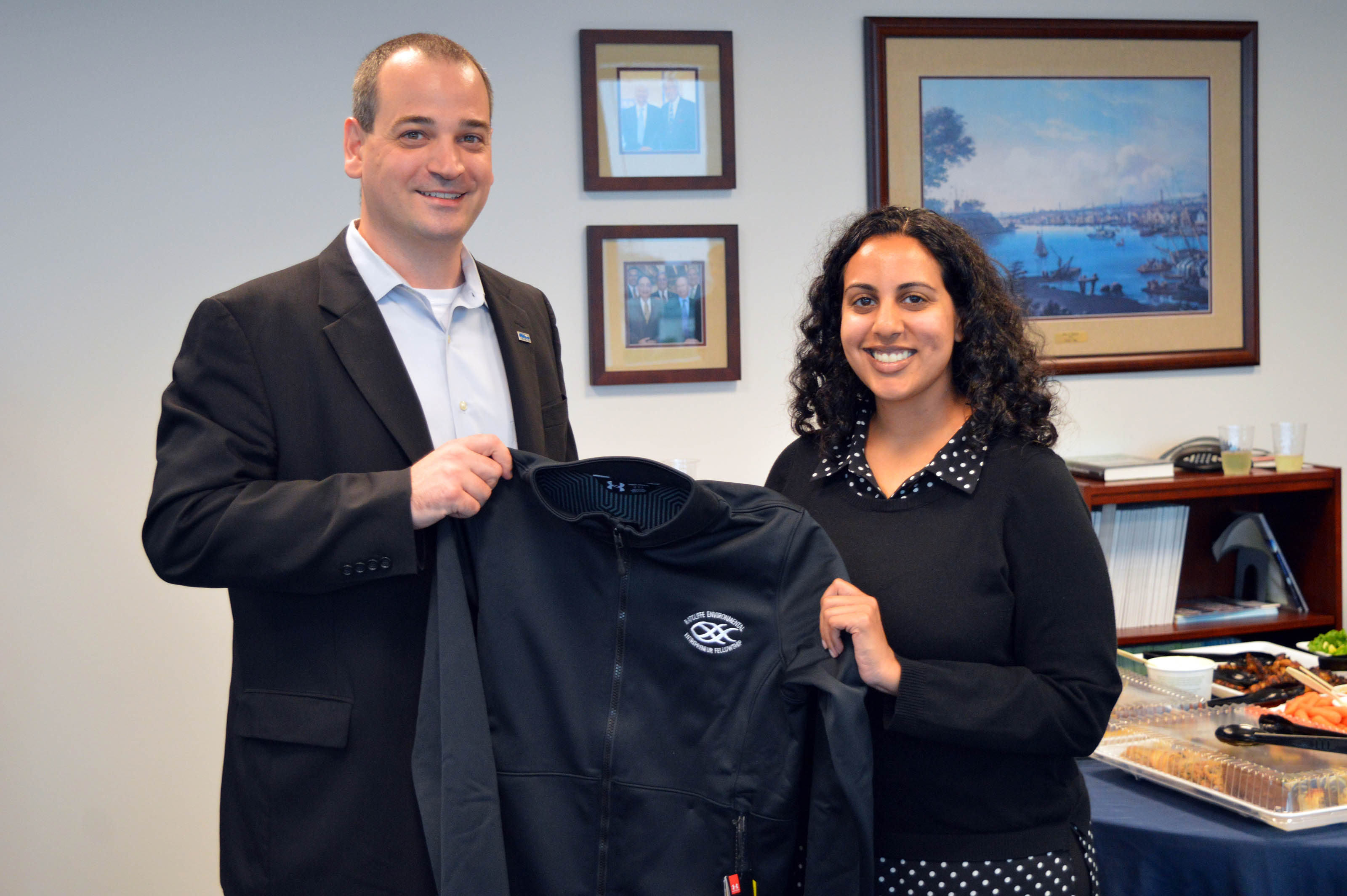 Saddef Haq receives her REEF jacket from Nicholas Hammond. 