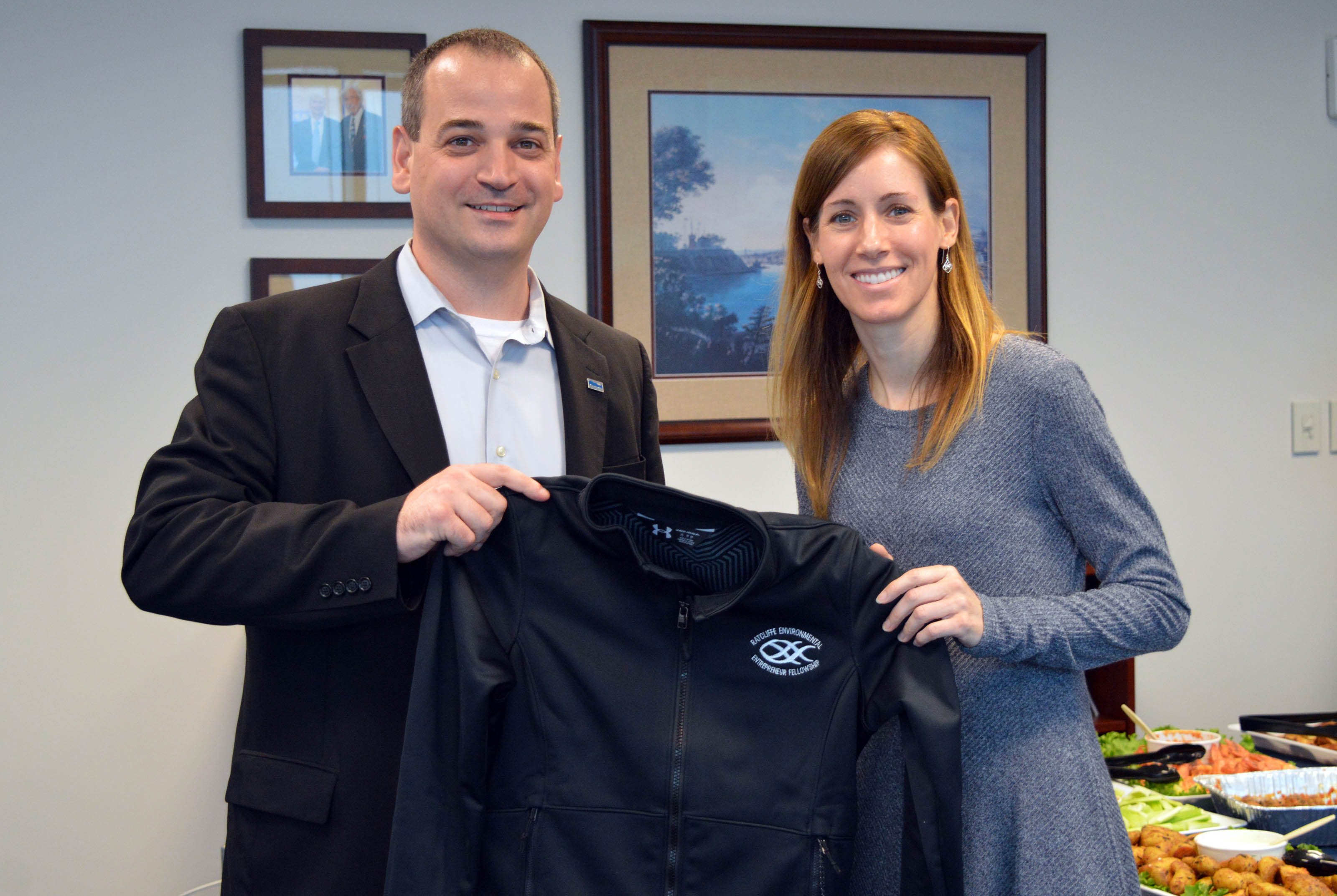 Mary Larkin receives her REEF jacket from Nicholas Hammond. 