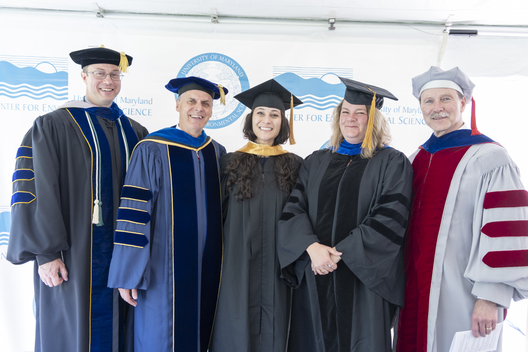 A group of mentors and students at commencement