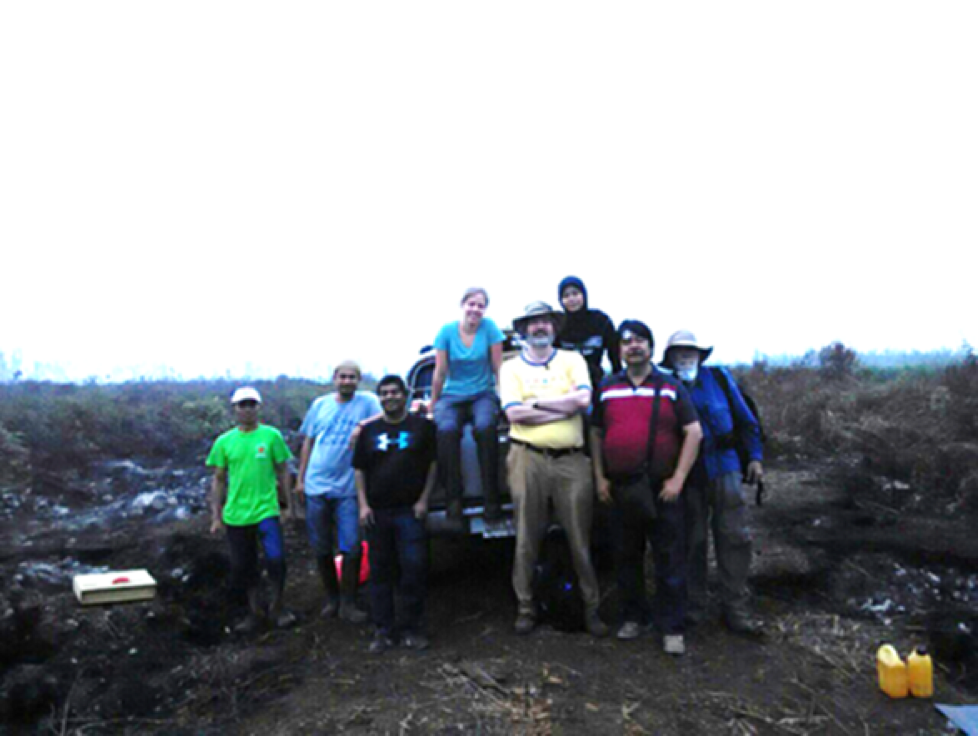 Mark Cochrane poses with his research team during field work.