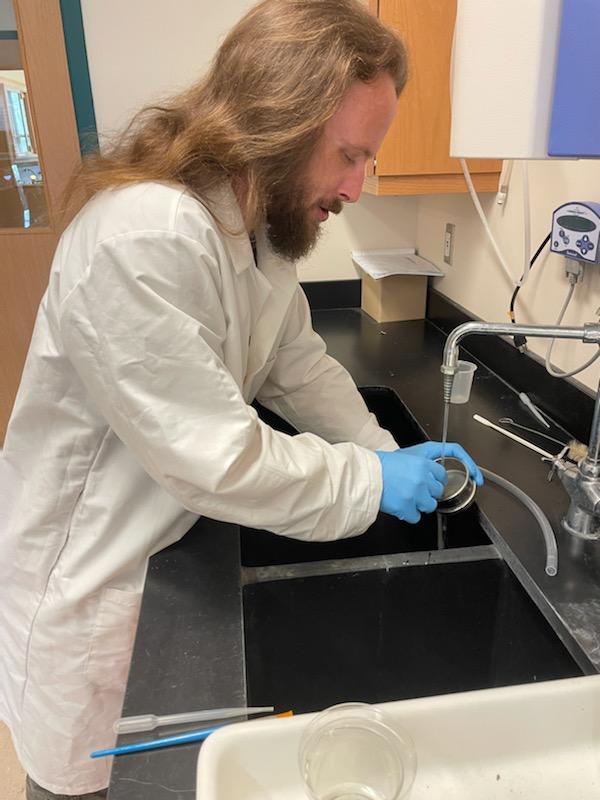 Richard Johnson working at sink in laboratory