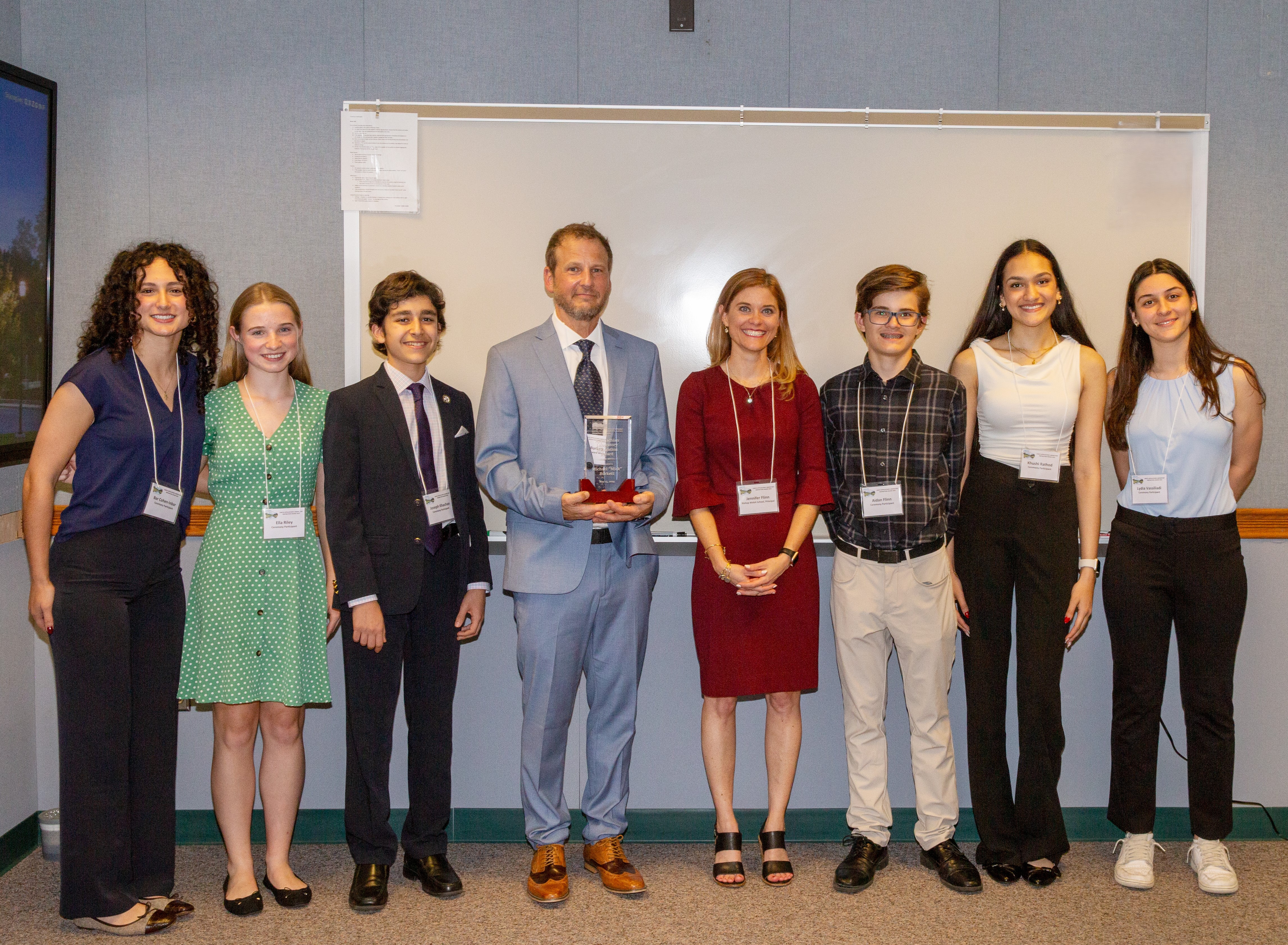 Mick Burkett pictured with Jennifer Flinn and six current and former students.