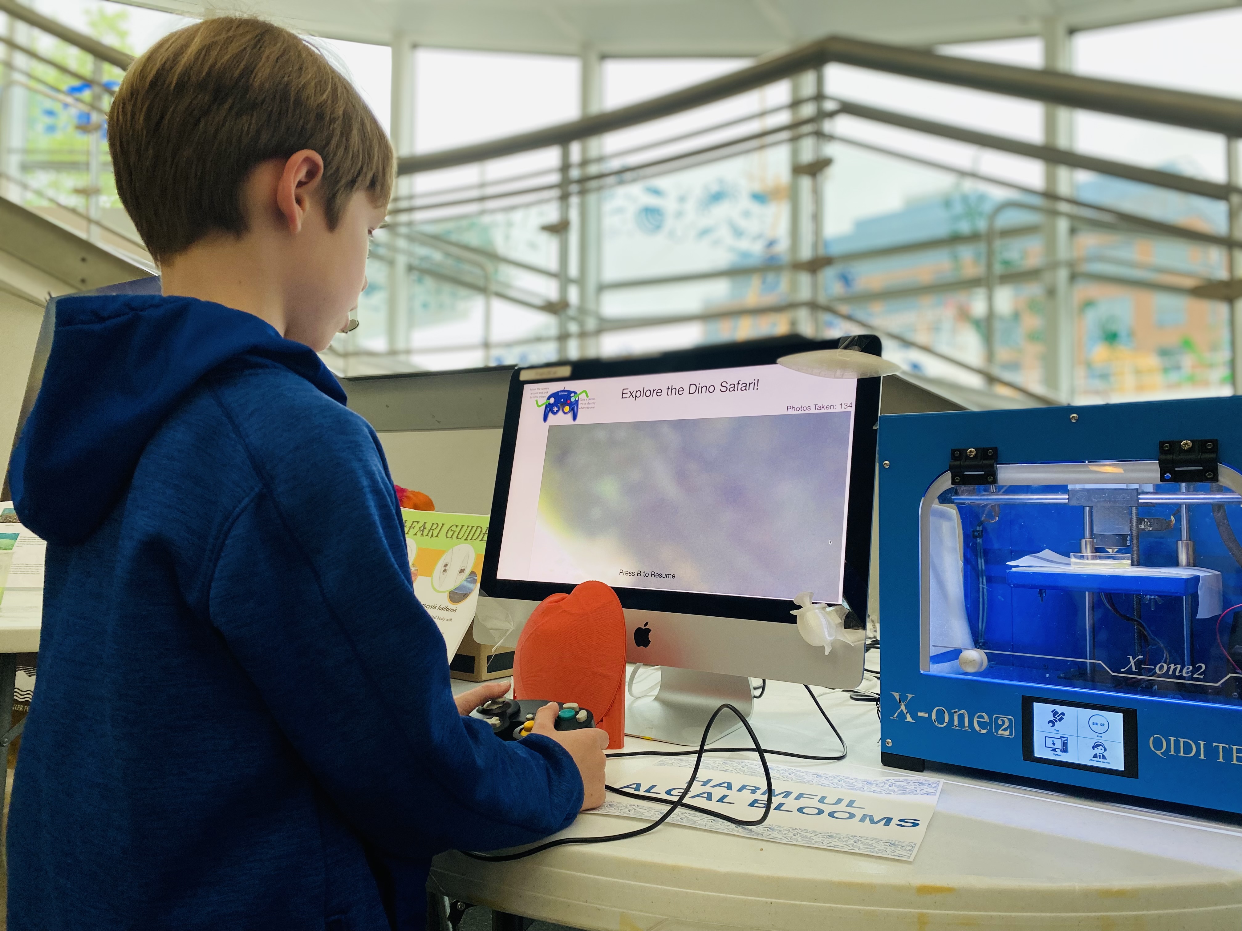 An attendee of the 2024 IMET Open House explores Wira's recycled GameCube invention.
