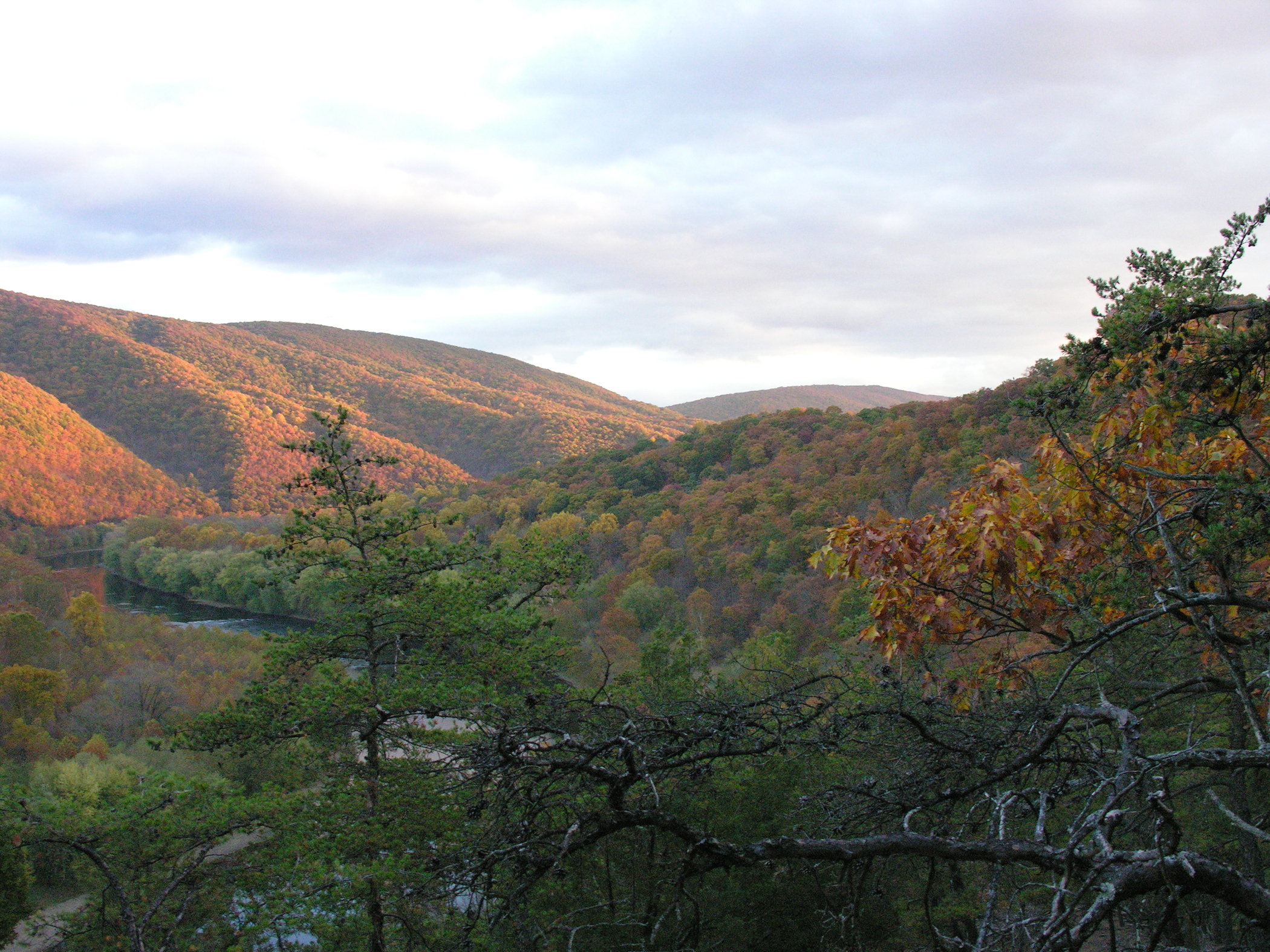 Landscape shot of rolling Appalachian hills of western MD with green, red and orange foliage. 