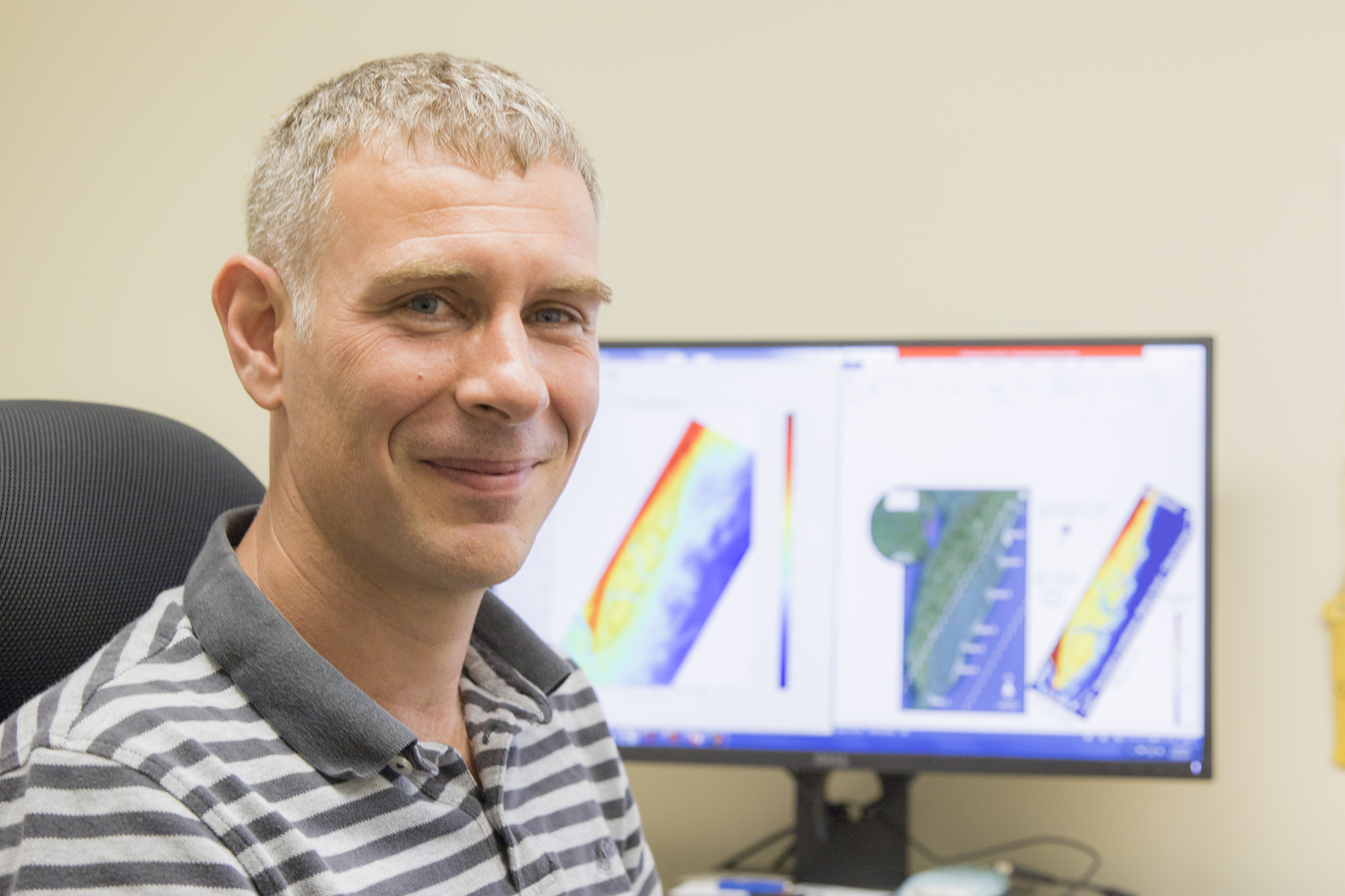 William Nardin in front of his computer modeling data
