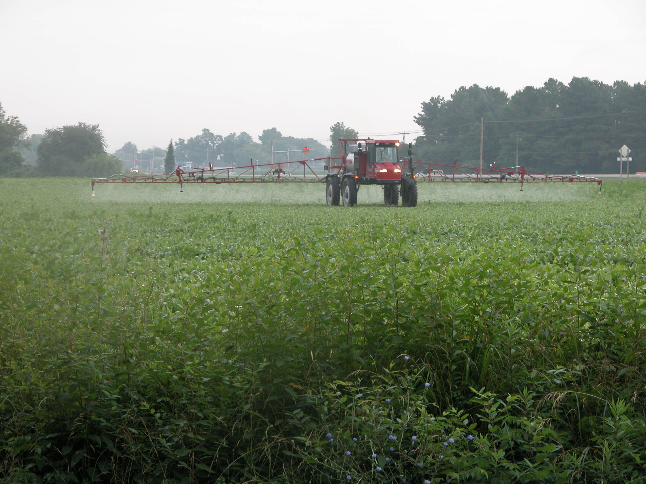 A tractor sprays herbicides on a Maryland farm.