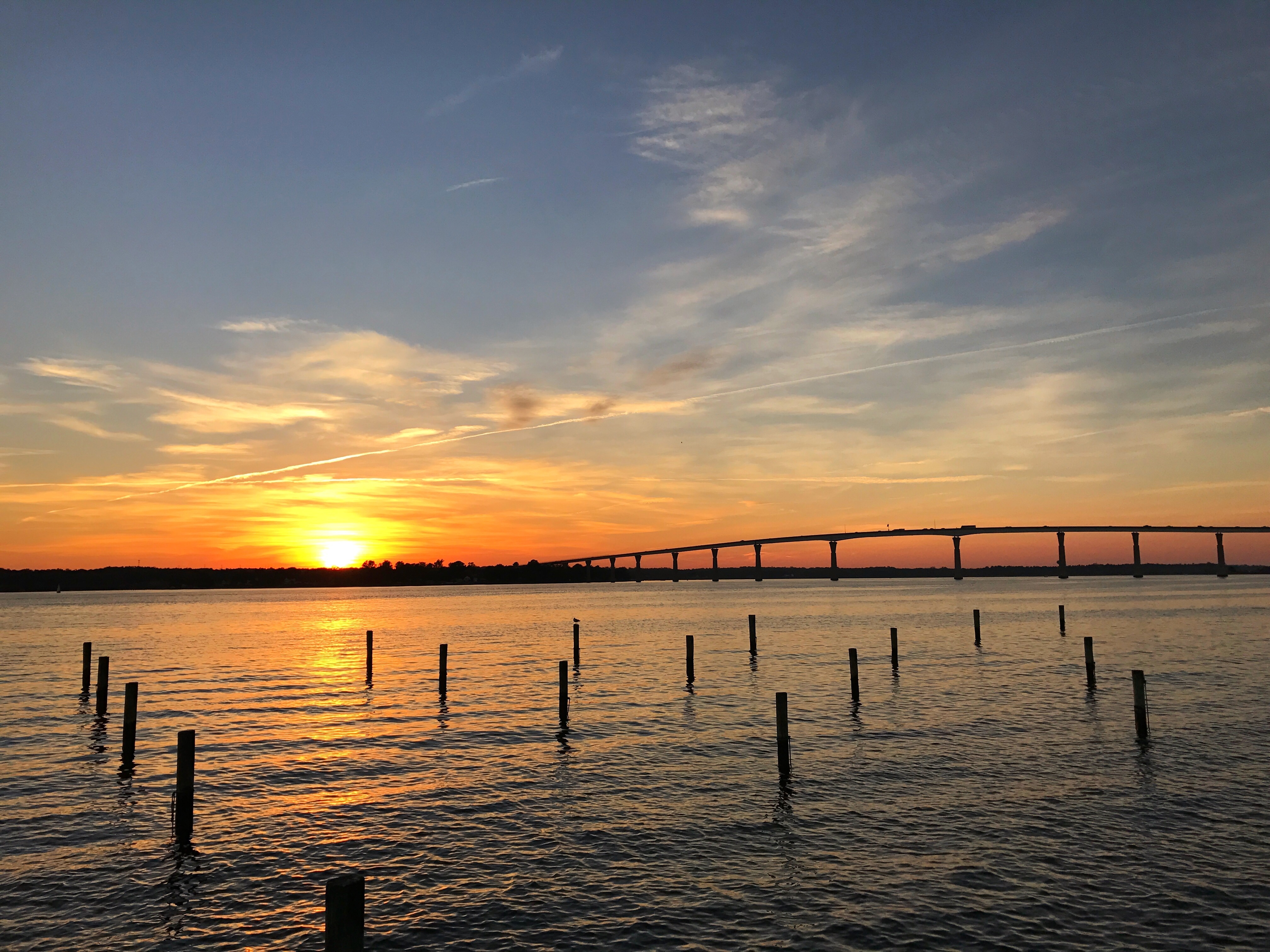 The sun sets over Chesapeake Bay at the Solomons bridge.